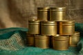 Stacked unopened cans on green cloth. Golden colored tins with canned food. Royalty Free Stock Photo