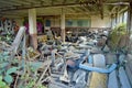 Stacked up car seats in an abandoned car garage.