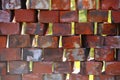 Stacked used bricks in front of blurred background