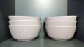 Stacked white ceramic bowls on shelf Royalty Free Stock Photo
