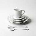 Stacked White Ceramic Dinner Plates Mug and Cutlery on White Background dinnerware Royalty Free Stock Photo