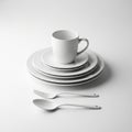 Stacked White Ceramic Dinnerware Set with Mug Fork and Spoon on White Background plate Royalty Free Stock Photo
