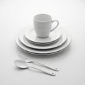 Stacked White Ceramic Dinnerware Set with Mug Spoon and Fork on White Background plate dish Royalty Free Stock Photo