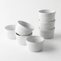 Stacked White Ceramic Ramekins with Ribbed Texture on White Background dish bowl Royalty Free Stock Photo