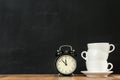 Stacked white coffee cups with retro alarm clock Royalty Free Stock Photo