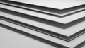Stacked white paper or cardstock sheets with subtle shadow and light creating a clean minimalist background for projects Keywords Royalty Free Stock Photo