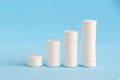 Stacked white pills on the blue background Royalty Free Stock Photo