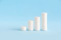 Stacked white pills on the blue background Royalty Free Stock Photo