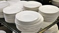 Stacked white plates on shelf, retail store Royalty Free Stock Photo