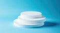 Stacked white round platforms over blue background empty space for product display and design Royalty Free Stock Photo
