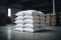 Stacked white sacks in a warehouse. Concept of storage and logistics