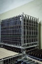 Stacked wine bottles in metal grids before to be labeled