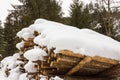 Stacked wood covered with snow, alps Austria in Salzburg