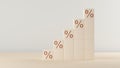 Stacked wood cubes with percentage sign imprint rising graph on table background, rising interest rates or inflation business