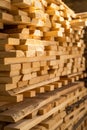 Stacked wooden planks in close-up at lumber warehouse. Air-drying timber stack. Wood air drying. Wood for house