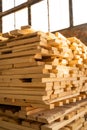 Stacked wooden planks in close-up at a outdoor lumber warehouse. Drying timber stack. Wood air drying.