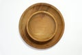 Stacked wooden plates with wooden bowls isolated on white background Royalty Free Stock Photo