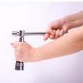 Stacked wrench in the hand of a girl. Symbol of hard work, feminism and labor day. Isolate on white background
