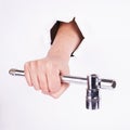 Stacked wrench in the hand of a girl. Symbol of hard work, feminism and labor day. Isolate on white background