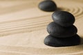 Stacked zen garden stones on sand with pattern, space for text Royalty Free Stock Photo