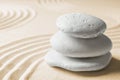 Stacked zen garden stones on sand with pattern, space for text Royalty Free Stock Photo