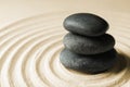 Stacked zen garden stones on sand with pattern Royalty Free Stock Photo