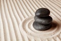 Stacked zen garden stones on sand with pattern, space for text. Royalty Free Stock Photo