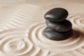 Stacked zen garden stones on sand with pattern, space for text Royalty Free Stock Photo