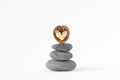 Stacked Zen stones with walnut heart on white background - Concept of love and balance Royalty Free Stock Photo