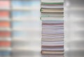 Stacking books with blur bookshelfs background in library room