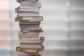Stacking books with blur bookshelfs background in library room