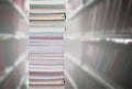 Stacking books with blur bookshelfs background in library room