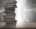 Stacking books on wood desk with blur bookshelfs background