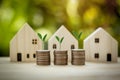 Stacking coins with tree in front of houses model.