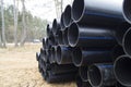 Stacking a large diameter water pipes of polyethylene.
