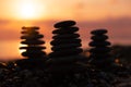 Stacking rocks on the beach with a sunset ocean Royalty Free Stock Photo