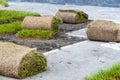 stacking of roll green lawn grass. Laying lawn grass in rolls at place of growth