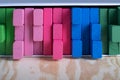 Stacking tower game of colorful wooden blocks. Jenga game of multi color unevenly shifted wooden beams. Royalty Free Stock Photo