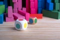 Stacking tower game of colorful wooden blocks. Jenga game of multi color unevenly shifted wooden beams. Royalty Free Stock Photo