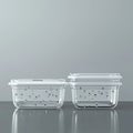 Stacking two clear plastic storage containers on a reflective surface Royalty Free Stock Photo