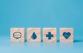 Stacking wooden block cube which print screen health care and medical icons for healthy and wellness concept. Healthcare and