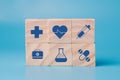 Stacking wooden block cube which print screen health care and medical icons for healthy and wellness concept. Healthcare and