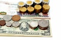 stacks of American coins of 1 dollar, 50 cents, quarters, 10 cents dime and one cent and Egyptian coins of 1 EGP LE one pound and Royalty Free Stock Photo