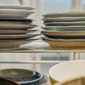 Stacks of Japanese bowls and plates in kitchen drawer.