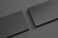 2 stacks of black blank textured business cards on dark paper background, us size 3.5 x 2 inches, as template for design