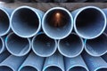 Stacks of black plastic pipes. Round ends close up Royalty Free Stock Photo