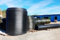 Stacks of black pvc plastic pipe outdoors with selective focus Royalty Free Stock Photo