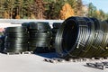 Stacks of black pvc plastic pipe outdoors with selective focus Royalty Free Stock Photo