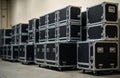 Stacks of black road cases hold music and video gear backstage. These heavy trunks are ready for transport, loading, or unloading Royalty Free Stock Photo