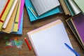 Stacks of books and blank sheets of paper on dark rustic table. Copy space Royalty Free Stock Photo